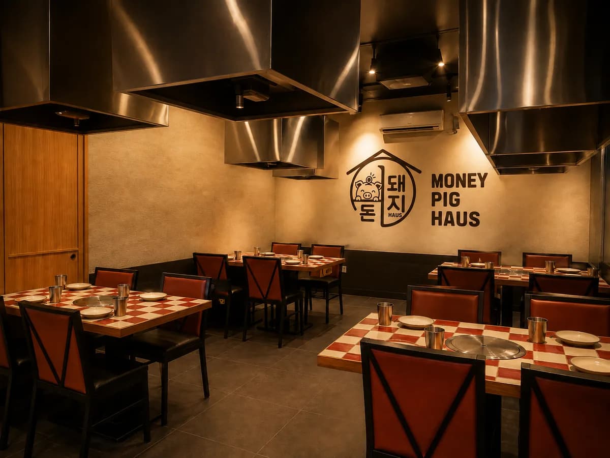 AI concept interior: a dining room with wood-framed tables, red-and-white tiled tops, a steel extraction hood hanging above each one, and the Money Pig Haus mark on the back wall.